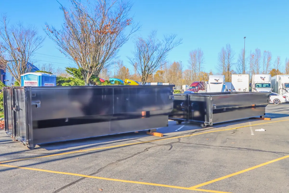 Professional dumpster rental service with roll-off container on residential driveway in Neenah